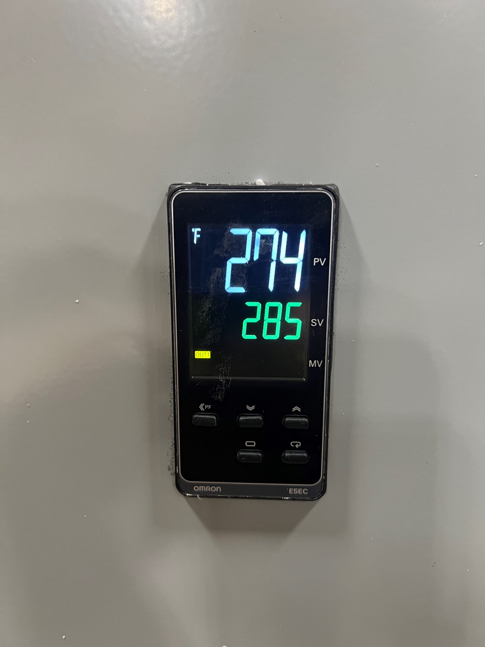 A digital temperature controller, ideal for styrofoam recycling applications, displays 274°F as the process value in blue and 285°F as the set value in green. Four buttons and a small Omron logo are visible at the bottom, making it a reliable choice for Better Densifiers or PolyWiz systems.