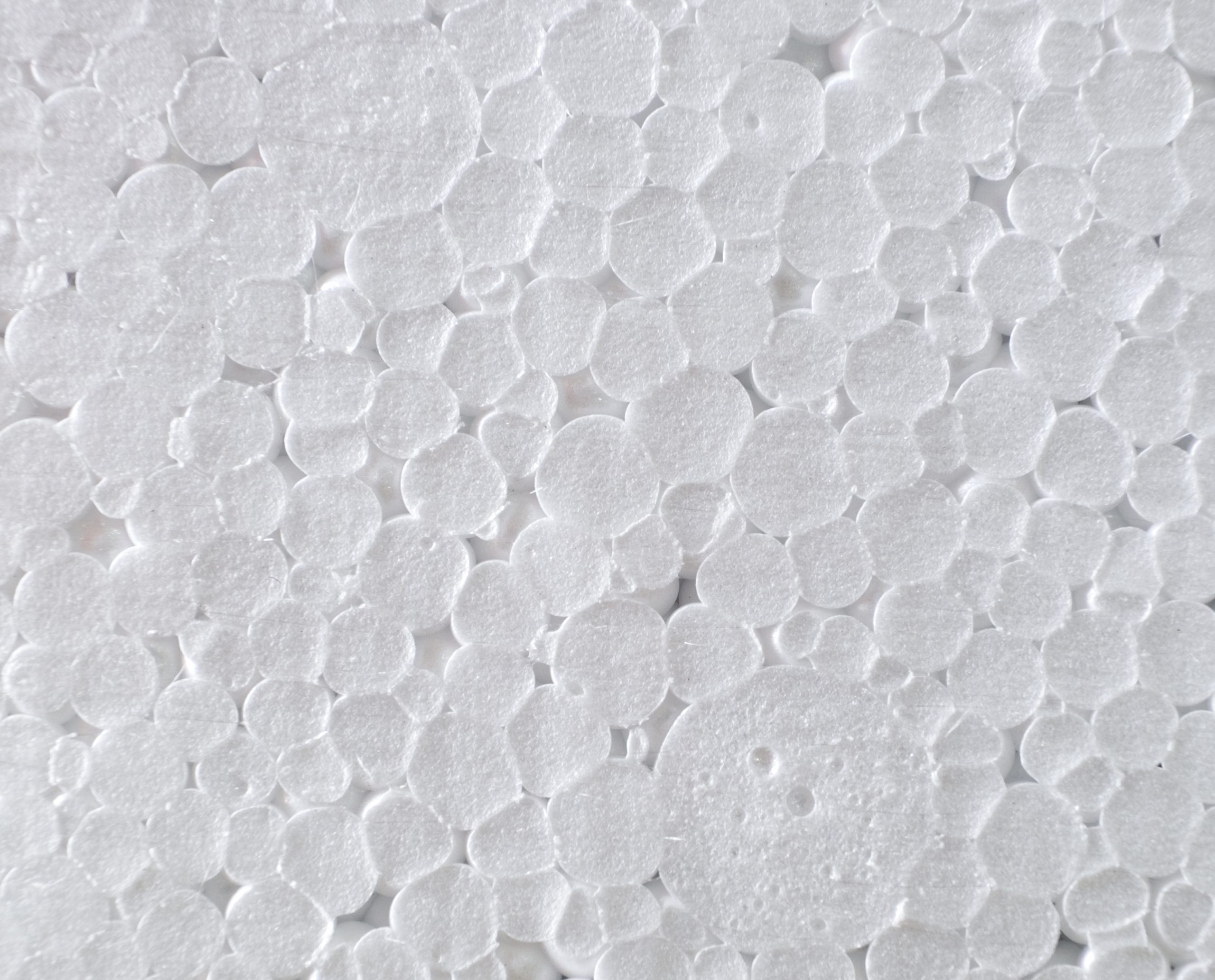 Close-up of white polystyrene foam showing tightly packed, round, textured beads—ideal material for styrofoam recycling with Better Densifiers or advanced solutions like PolyWiz.